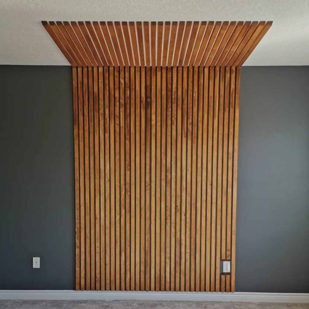 Vertical wooden slats forming an accent wall that extends onto the ceiling against a grey wall.