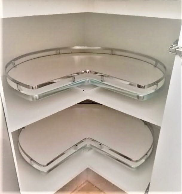 Two white corner cabinet shelves featuring rotating clear glass trays with silver metal rims.